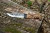 Handmade Bushcraft Knife 2.0 with a bent handle and texture on the metal