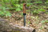 Handmade Bushcraft Knife 2.0 with a bent handle and texture on the metal