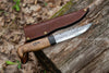 Handmade Bushcraft Knife 2.0 with a bent handle and texture on the metal